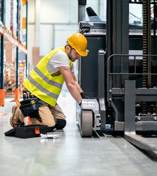 man repair forklift